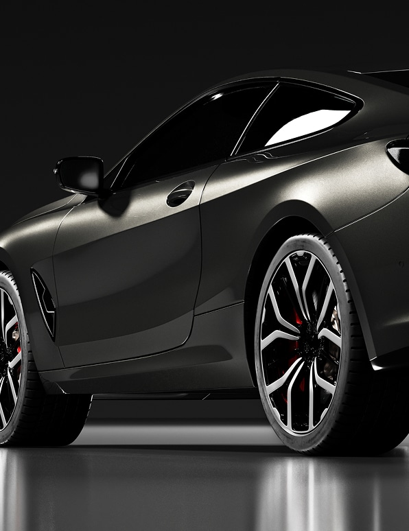 Coupé sport de luxe anthracite, vue latérale basse. Jantes bicolores design avec étriers de frein rouges. Éclairage studio réfléchi.